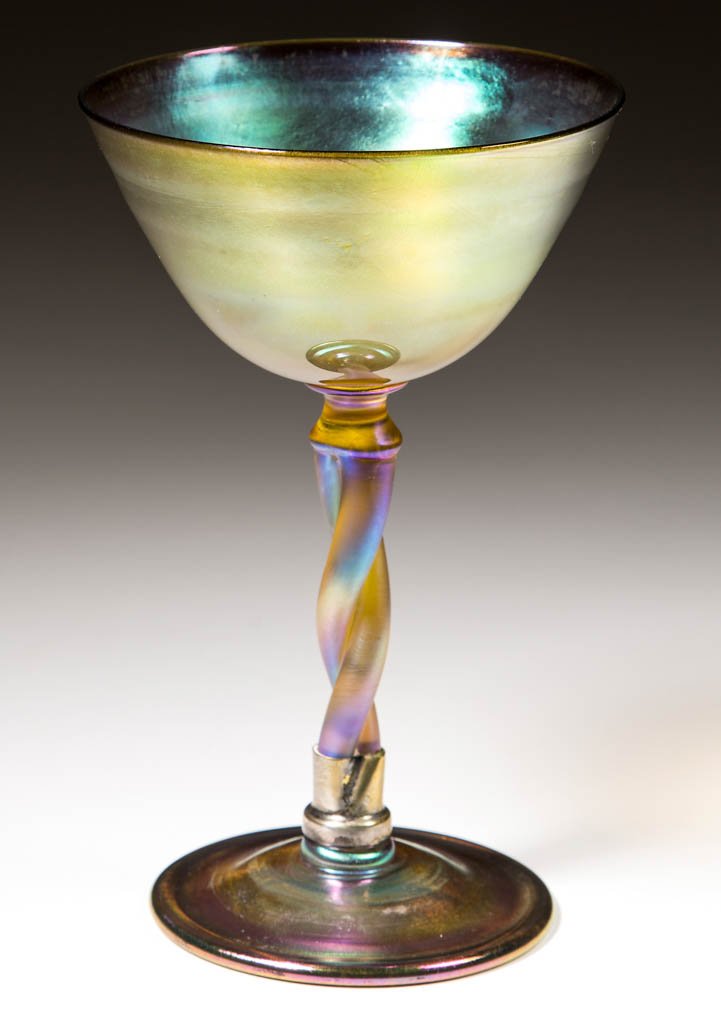 TIFFANY FAVRILE TWISTED-STEM WINE: TIFFANY FAVRILE TWISTED-STEM WINE, golden iridescent, iridescence to the interior bowl, glossy exterior, signed, "L.C.T./M8749". Tiffany Studios. 1900. 6 1/4" H, 3 7/8" D bowl. Repair between the foot