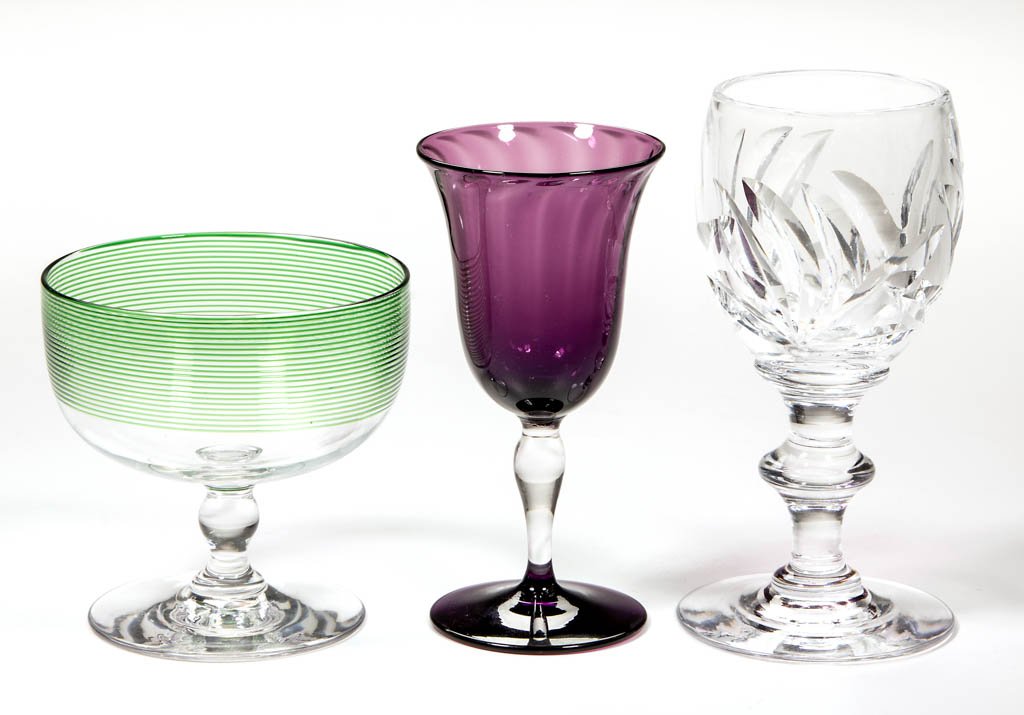 ASSORTED STEUBEN ART GLASS ARTICLES, LOT OF THREE: ASSORTED STEUBEN ART GLASS ARTICLES, LOT OF THREE, comprising a colorless cut-glass wine with a faint signature, an amethyst swirled wine with polished pontil mark, and a colorless sherbet with applie