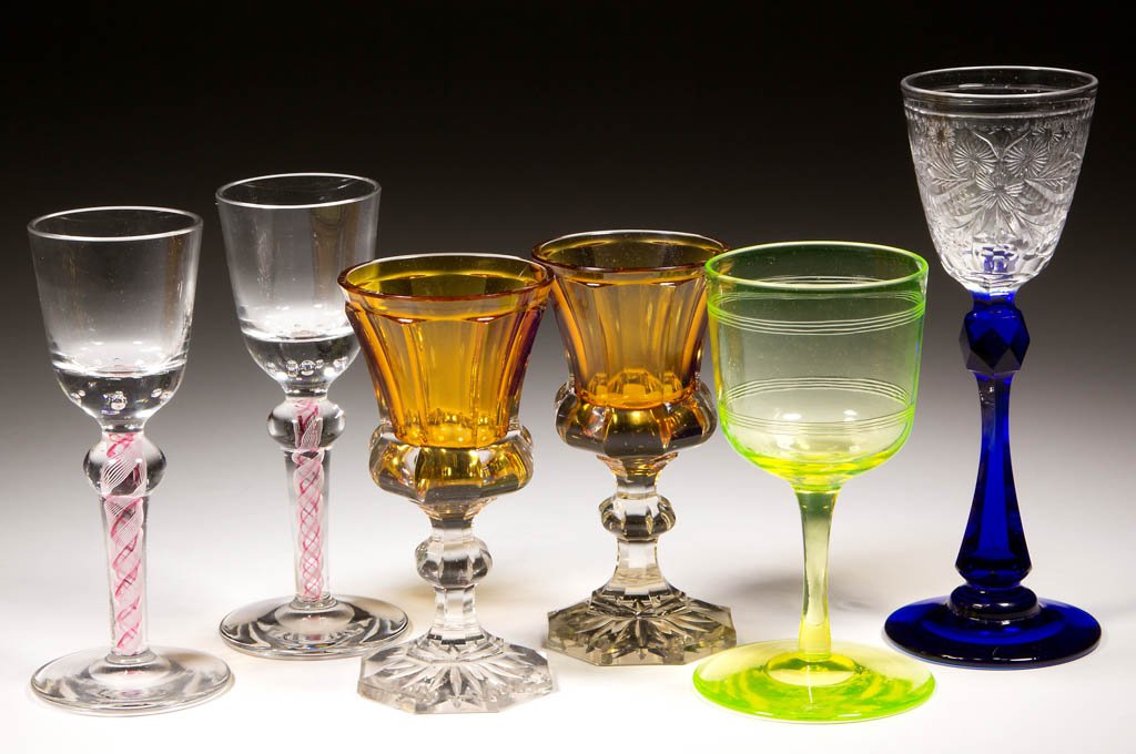ASSORTED COLORED WINE GLASSES, LOT OF SIX: ASSORTED COLORED WINE GLASSES, LOT OF SIX, comprising a pair of amber cased colorless panel-cut examples with thistle-shape bowls, a pair of colorless with teared bowls raised on pink and white enamel