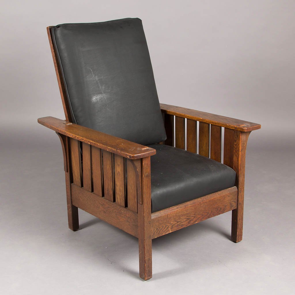 AMERICAN ARTS AND CRAFTS / MISSION QUARTER-SAWN OAK: AMERICAN ARTS AND CRAFTS / MISSION QUARTER-SAWN OAK MORRIS CHAIR, later black vinyl upholstered cushions. Retains likely original surface with rich color. First quarter 20th century. 40 1/2" H, 19" x 