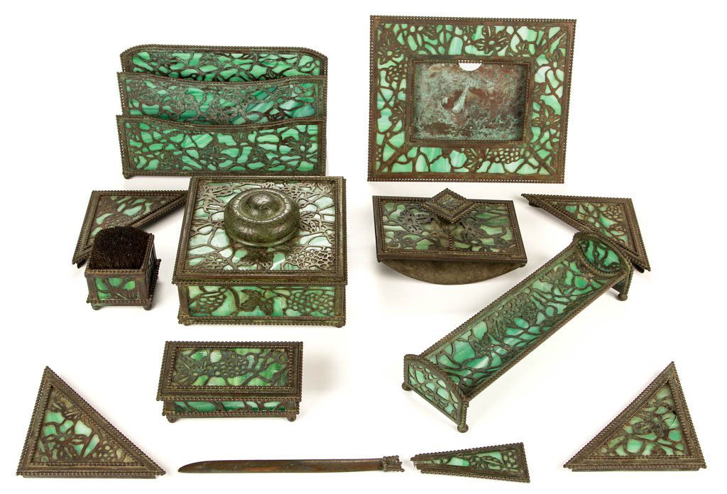 RIVIERE STUDIOS GRAPEVINE 12-PIECE DESK SET: RIVIERE STUDIOS GRAPEVINE 12-PIECE DESK SET, green slag glass, including an inkwell, letter holder, picture frame, and pen holder; all but corner blotters signed. New York. Early 20th century. 1/2" to