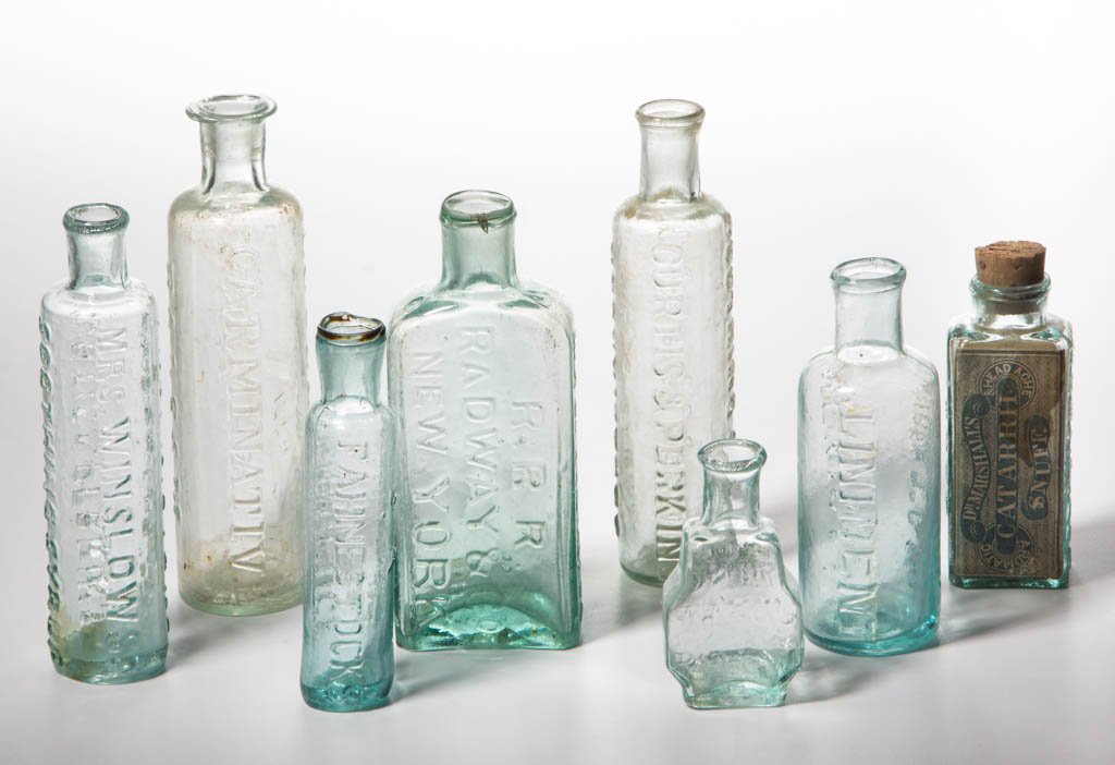 ASSORTED EMBOSSED AND PONTILED COMMERCIAL BOTTLES, LOT: ASSORTED EMBOSSED AND PONTILED COMMERCIAL BOTTLES, LOT OF EIGHT, shades of aquamarine, including Turlington's Balsam, Marshall's snuff with labels, Louden & Co's balsam, and Mexican Mustang liniment, 