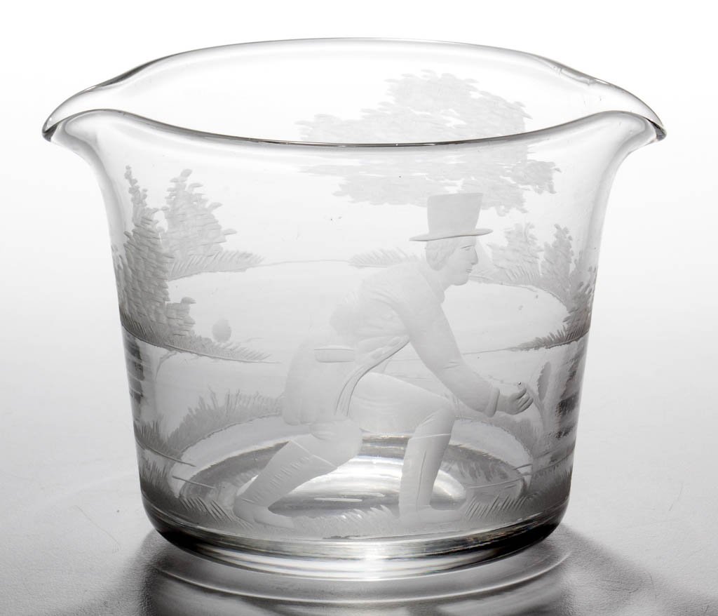 ENGLISH FREE-BLOWN AND ENGRAVED LAWN BOWLING WINE: ENGLISH FREE-BLOWN AND ENGRAVED LAWN BOWLING WINE RINSER, colorless lead glass, slight tapered form with two spouts, featuring a detailed depiction of a gentleman in top hat lawn bowling in a landscap