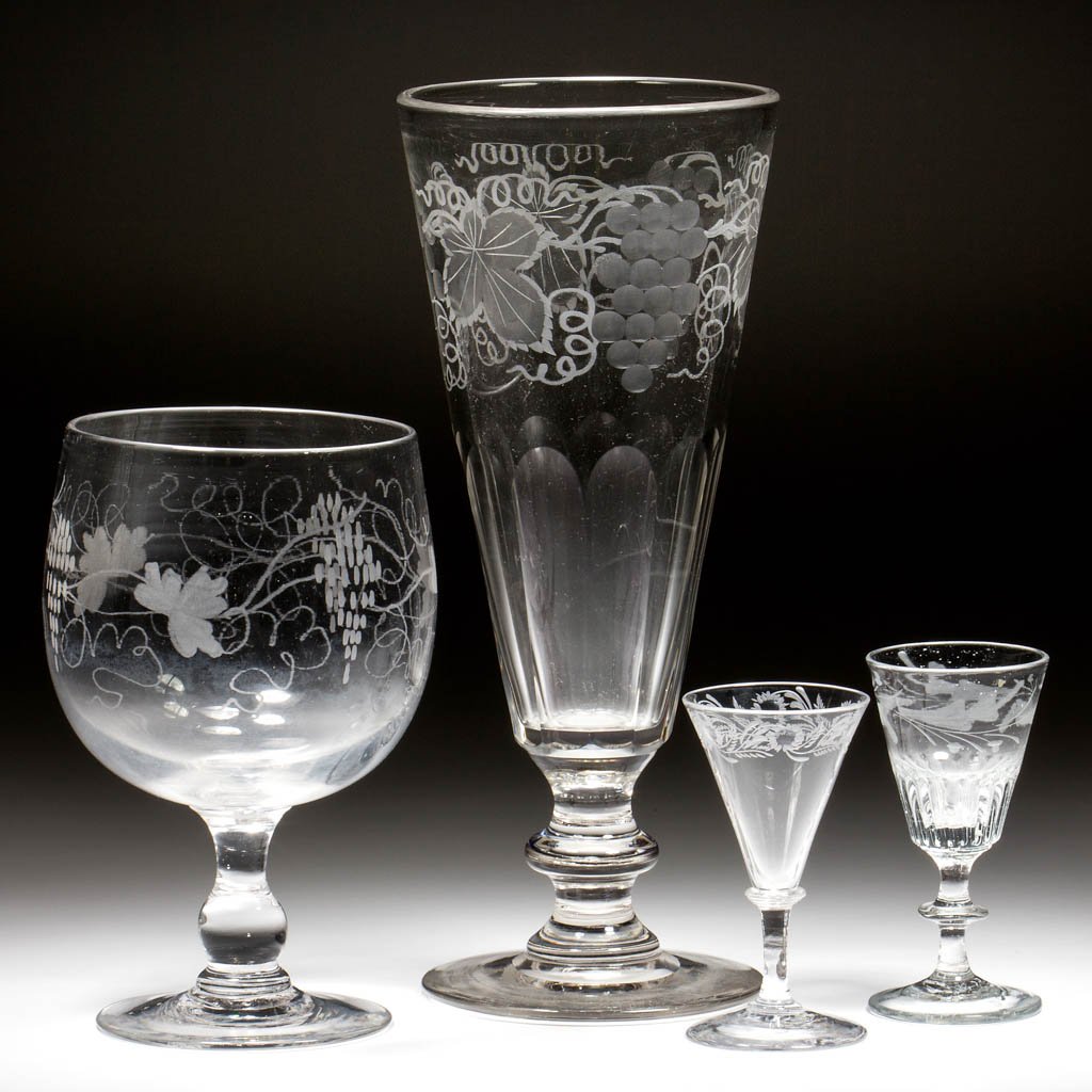 ASSORTED ENGRAVED ARTICLES, LOT OF FOUR: ASSORTED ENGRAVED ARTICLES, LOT OF FOUR, colorless, comprising a chalice with Vintage decoration, a dip-molded wine, a floral decorated wine with a conical bowl, and a large conical vase with cut pane