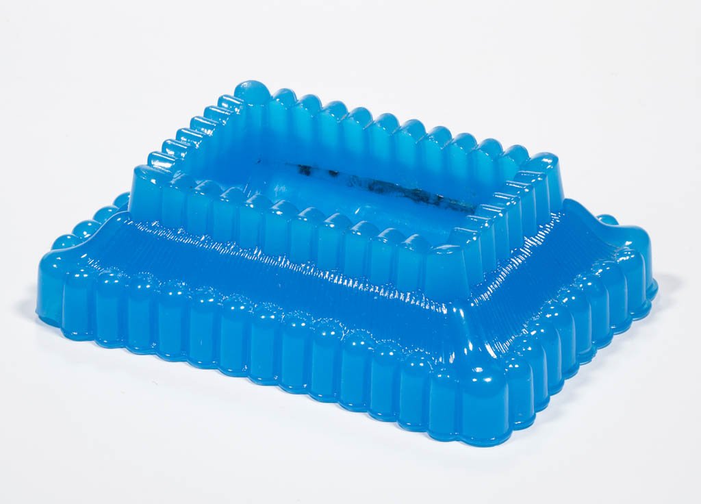 SANDWICH PRESSED RIBBED / ONION MATCH TRAY: SANDWICH PRESSED RIBBED / ONION MATCH TRAY, translucent starch blue, rectangular form with a ribbed gallery, deep concave well, striker sides and a ribbed base. Boston & Sandwich Glass Co. 1860-1880. 
