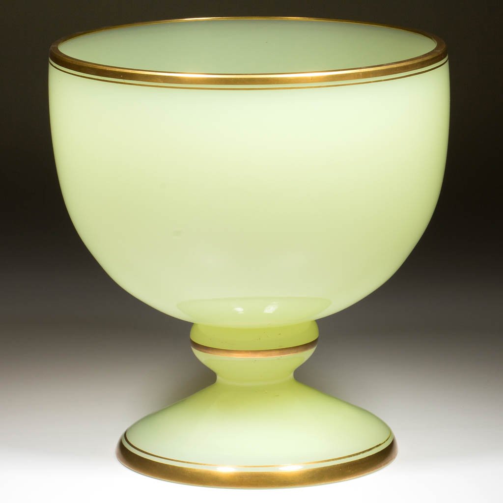 CONTINENTAL BLOWN OPALINE PUNCH BOWL ON FOOT: CONTINENTAL BLOWN OPALINE PUNCH BOWL ON FOOT, translucent yellow/Vaseline (black lighted) with gilt banding, hemispherical bowl raised on a compressed knop and domed foot. Late 19th/early 20th century