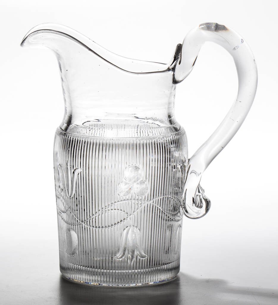 BELLFLOWER - DOUBLE VINE WATER PITCHER: BELLFLOWER - DOUBLE VINE WATER PITCHER, colorless lead glass, shouldered form with vines flowing right and left, ribs end in straight line at shoulder, applied solid handle, polished pontil mark. Prob