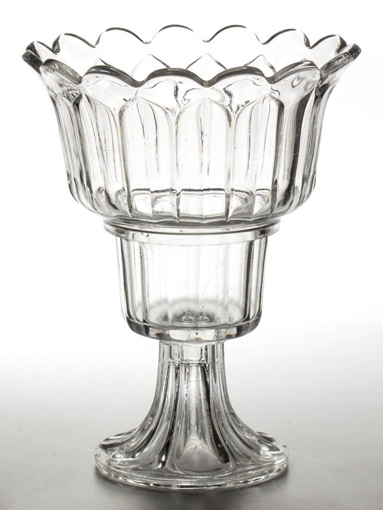 PRESSED ARCHED FLUTE WINE COOLER: PRESSED ARCHED FLUTE WINE COOLER, colorless lead glass, with a deep stepped bowl and 15-scallop rim, raised on an Elongated Loop foot, wafer construction. Boston & Sandwich Glass Co. 1860-1870. 11" H,