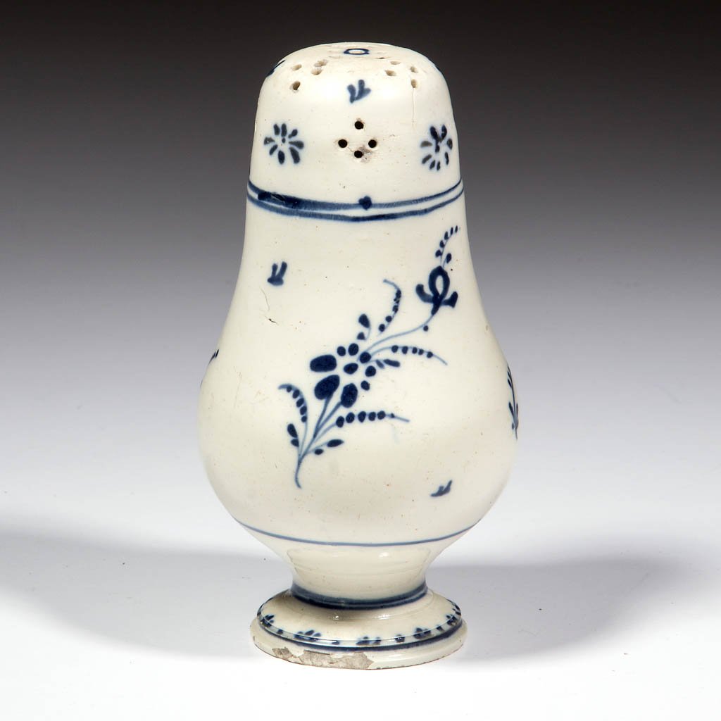 EUROPEAN CREAMWARE CERAMIC PEPPER POT: EUROPEAN CREAMWARE CERAMIC PEPPER POT, having clusters of piercing on top and one hole in the base for a stopper; decorated with floral sprays and lines in underglaze blue. Unmarked. Late 18th/early 1