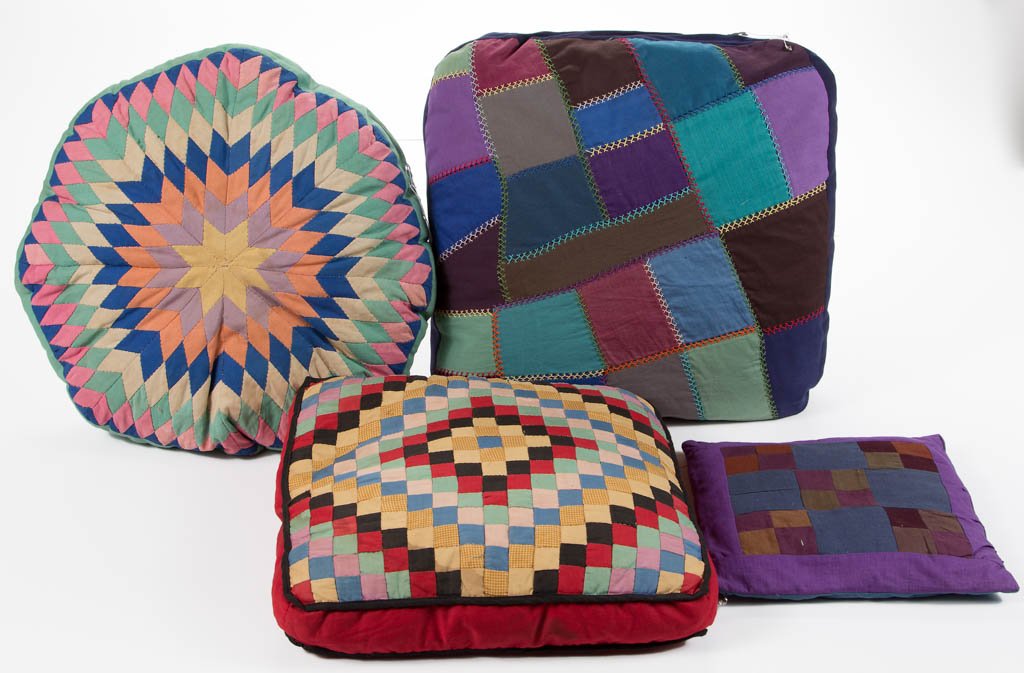 AMERICAN ARTICLES, LOT OF FOUR: AMERICAN ARTICLES, LOT OF FOUR, comprising cotton pillows and seat cushions, one small pillow pieced with "Nine Patch" in Amish colors from Pennsylvania; one large pieced and embroidered seat cushion 