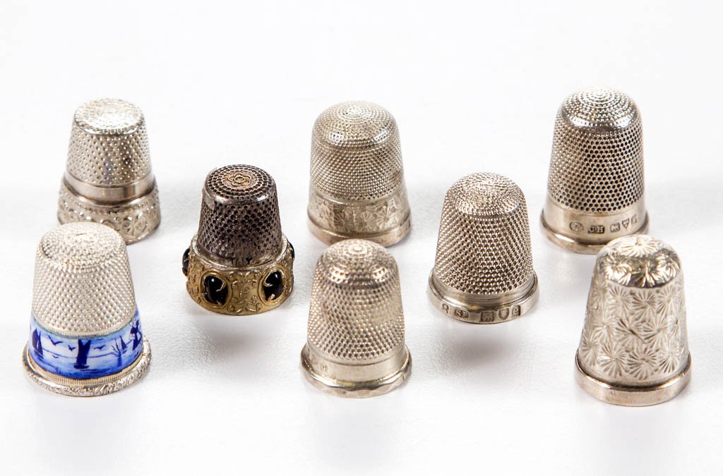 ASSORTED STERLING SILVER THIMBLES, LOT OF EIGHT: ASSORTED STERLING SILVER THIMBLES, LOT OF EIGHT, comprising two Charles Horner examples, two Henry Griffith & Sons, a German example with Delft blue and white enameled decoration, an Italian example w