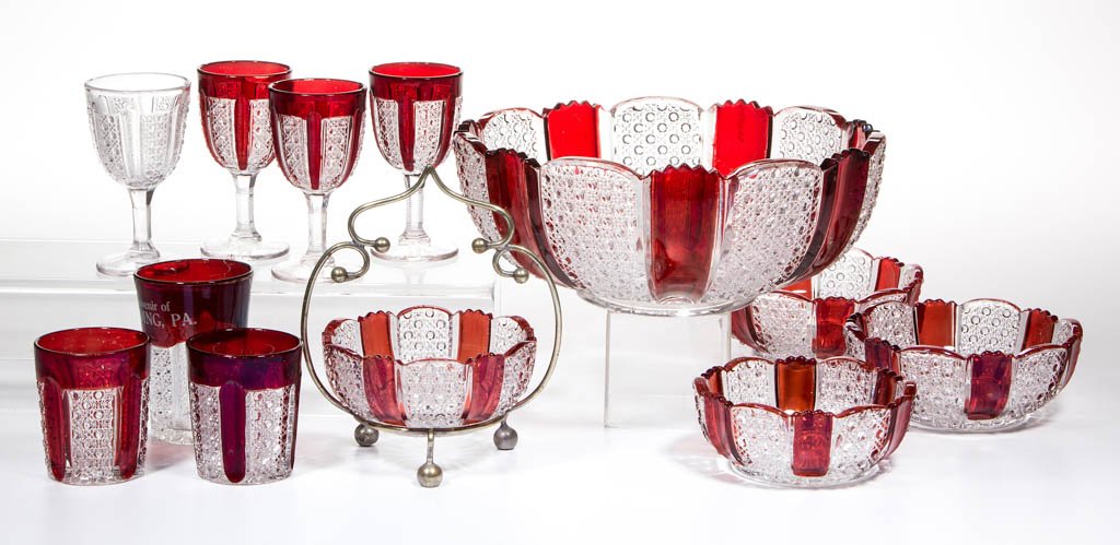 MCKEE'S RAINBOW - RUBY-STAINED ARTICLES, LOT OF 11: MCKEE'S RAINBOW - RUBY-STAINED ARTICLES, LOT OF 11, colorless, including a three-piece berry set, three wines, and two shot glasses. Together with a colorless Rainbow wine. 12 pieces total. McKee-Jean
