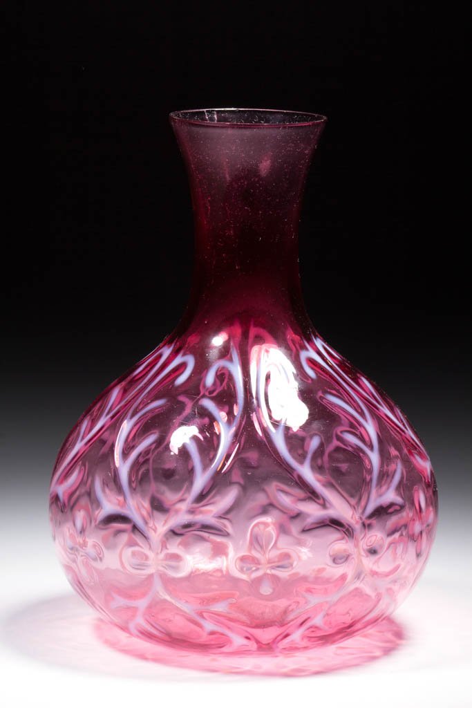OPALINE BROCADE / SPANISH LACE WATER CARAFE: OPALINE BROCADE / SPANISH LACE WATER CARAFE, cranberry opalescent, ball form, factory polished rim. Pattern introduced 1899. 8 1/8" H.Undamaged with three minor interior open bubbles, as made.Provenan