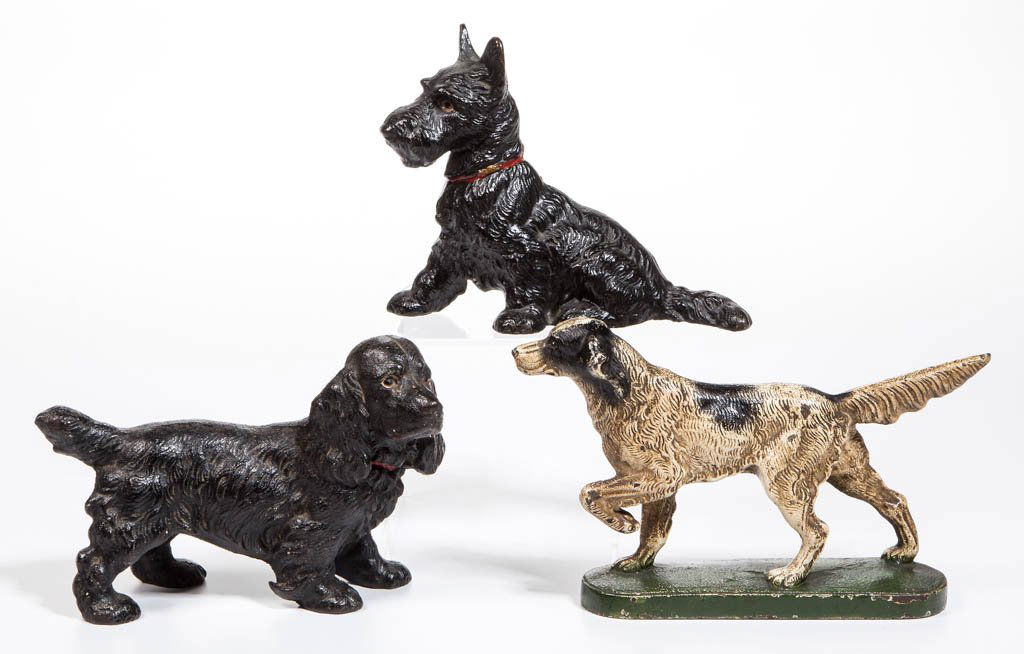 ASSORTED FIGURAL CANINE CAST-IRON DOORSTOPS, LOT OF: ASSORTED FIGURAL CANINE CAST-IRON DOORSTOPS, LOT OF THREE, each full figure with solid body and retaining original paint, comprising a seated Scottie, a Cocker Spaniel, and a Pointer. First half 20th