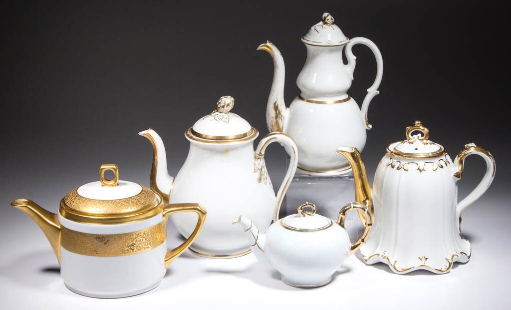 CONTINENTAL GILT-DECORATED CERAMIC TEAPOTS, LOT OF FIVE: CONTINENTAL GILT-DECORATED CERAMIC TEAPOTS, LOT OF FIVE, all having molded designs, gilding, and one with embossed gilt designs. One marked "J&C / Charlotte / Bavaria" made for Patsy Newhouse, Michiga