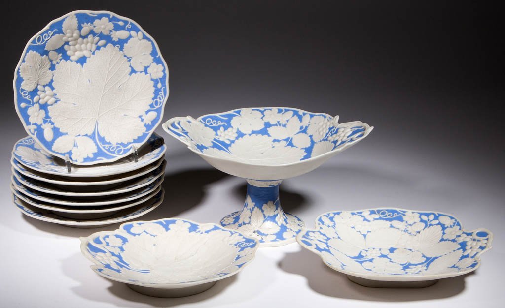 ENGLISH OR AMERICAN PARIAN PORCELAIN TABLE WARES, LOT: ENGLISH OR AMERICAN PARIAN PORCELAIN TABLE WARES, LOT OF TEN, comprising seven 8 1/2" D plates, one 9" D dish, one 10"x8 1/2" dish with handles extending from the sides, and one 5 3/4" H bolted compot