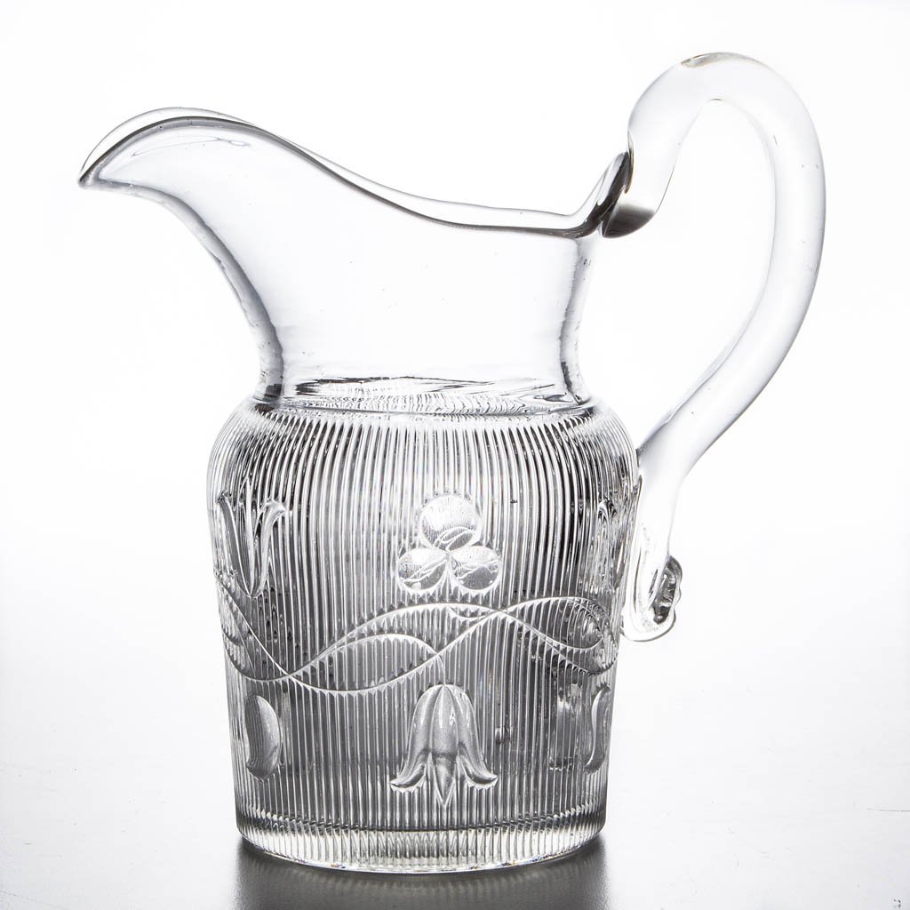 BELLFLOWER - DOUBLE VINE WATER PITCHER: BELLFLOWER - DOUBLE VINE WATER PITCHER, colorless lead glass, shouldered form with vines flowing right and left, ribs end in straight line at shoulder, applied solid handle, polished pontil mark. Prob