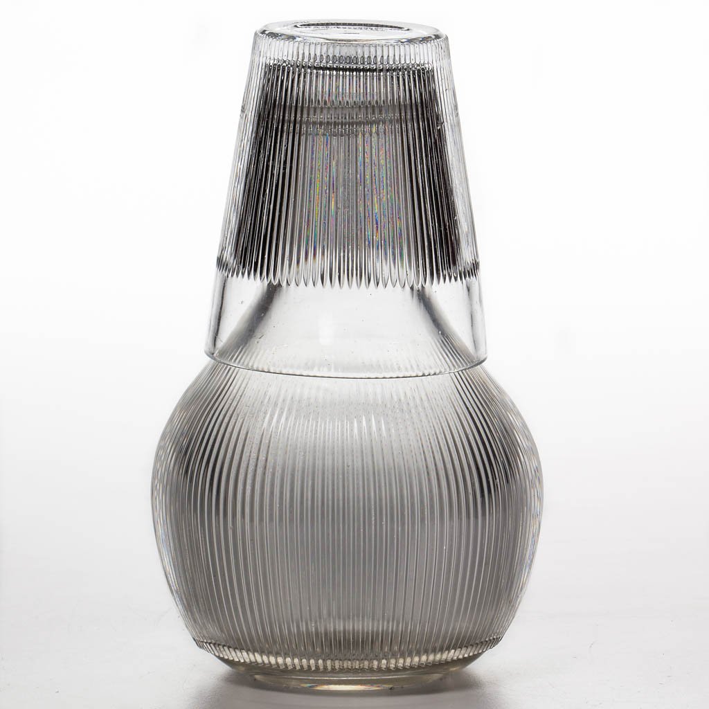 FINE RIB / REEDED (OMN) WATER BOTTLE AND TUMBLE-UP: FINE RIB / REEDED (OMN) WATER BOTTLE AND TUMBLE-UP, colorless lead glass, bulbous pint bottle with ribs ending at a plain band around the base, polished pontil mark, well-fitting tapered tumbler with 