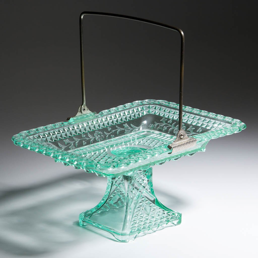 ADAMS NO. 140 / WILDFLOWER CAKE BASKET: ADAMS NO. 140 / WILDFLOWER CAKE BASKET, apple green, original metal handle. Adams & Co. Circa 1874. 5 1/8" H, 7 3/4" x 10 7/8". Undamaged. Provenance: Collection of William D. "Bill" Ross, Bean Statio