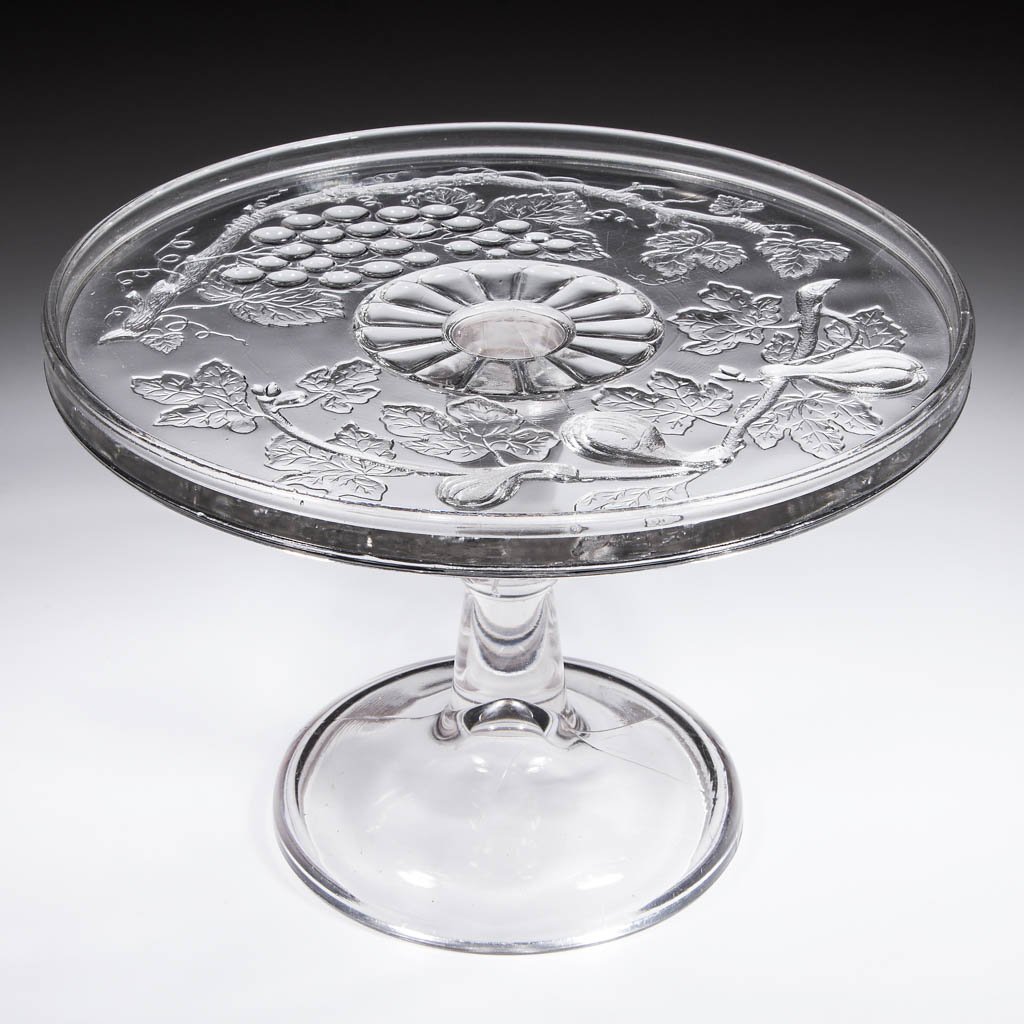 FRUITS SALVER / CAKE STAND: FRUITS SALVER / CAKE STAND, colorless. Maker unverified. Fourth quarter 19th century. 7" H, 10 3/8" D rim. Undamaged with moderate surface wear. Provenance: Collection of William D. "Bill" Ross, Bean 