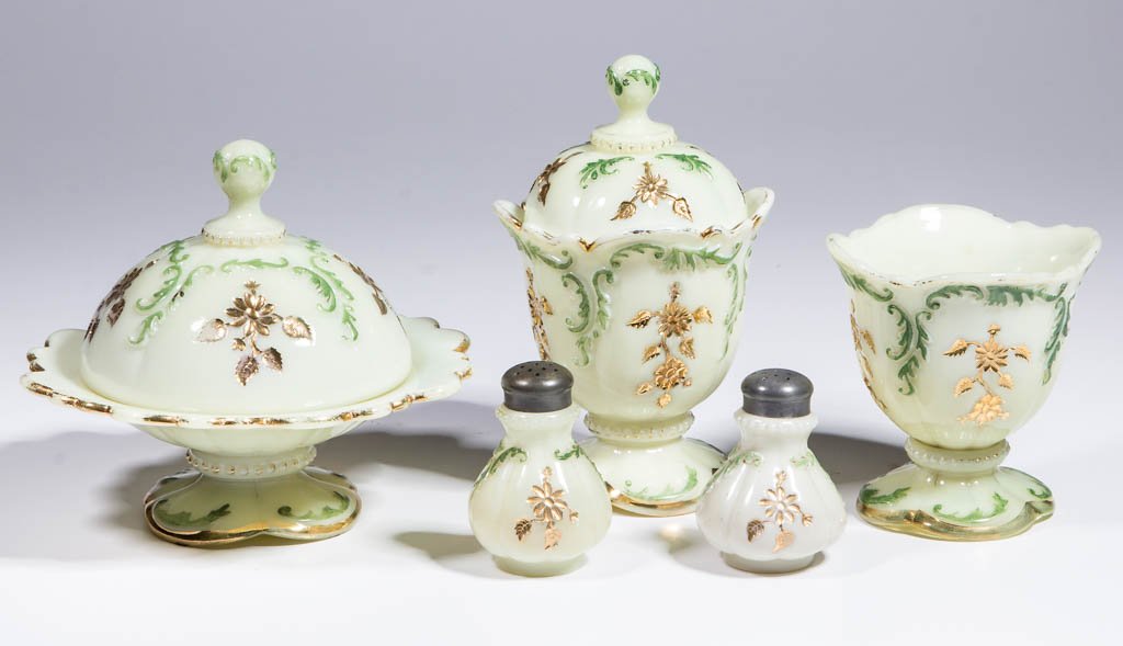NORTHWOOD INTAGLIO TABLE ARTICLES, LOT OF FIVE: NORTHWOOD INTAGLIO TABLE ARTICLES, LOT OF FIVE, custard with green stain and gilt decoration, comprising a covered butter dish, a covered sugar, a spooner, and a pair of salt/pepper shakers with perio