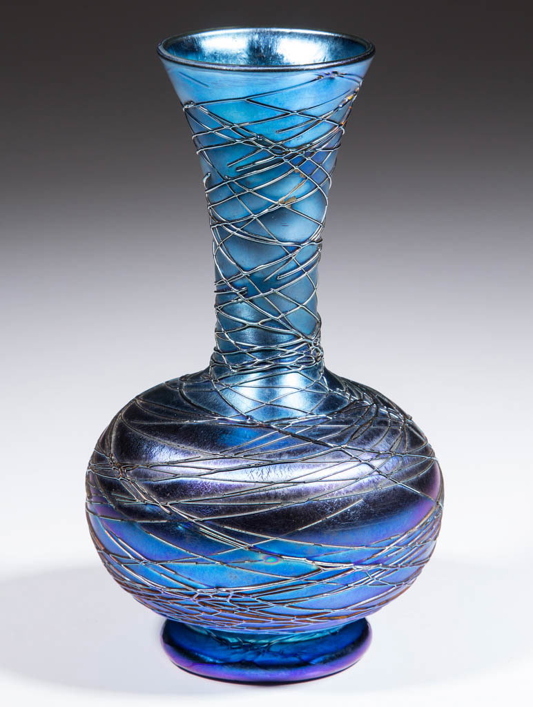DURAND BLUE IRIDESCENT ART GLASS FOOTED VASE: DURAND BLUE IRIDESCENT ART GLASS FOOTED VASE, bulbous body with a trumpet neck, blue iridescent spider-webbing throughout, polished pontil mark, signed, "Durand". Vineland Flint Glass Works. Circa 193