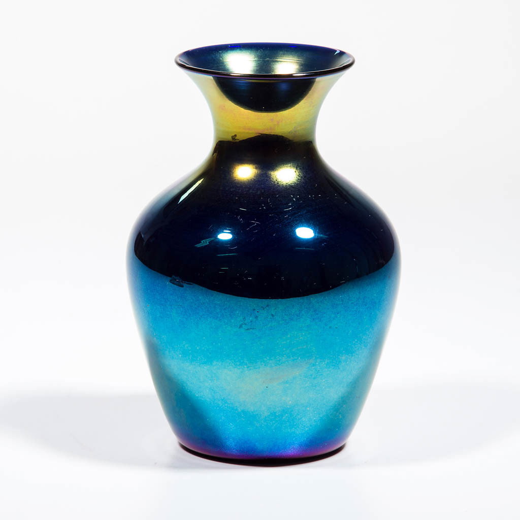 IMPERIAL IRIDESCENT FREE HAND VASE: IMPERIAL IRIDESCENT FREE HAND VASE, blue iridescent with a glossy finish, Lead Lustre 618-10, polished pontil mark. Imperial Glass Co. Circa 1925. 6 3/8" H, 3" D rim, 2 3/4" D base. Undamaged. Literat