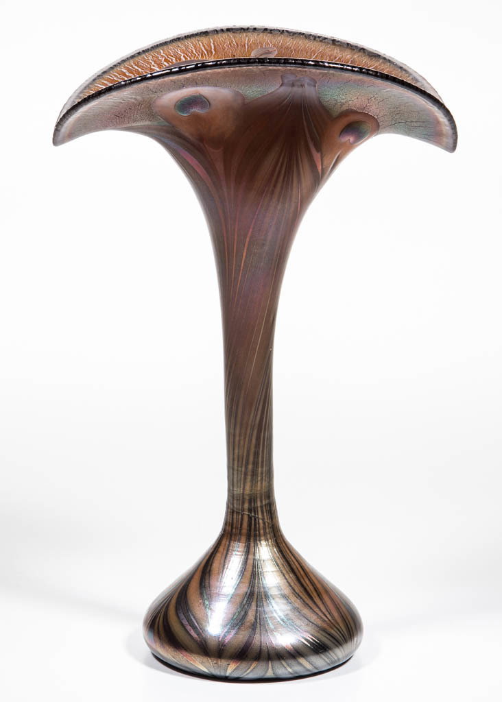 STUDIO ART GLASS PEACOCK FEATHER VASE: STUDIO ART GLASS PEACOCK FEATHER VASE, colorless, iridized surface with an umbrella-form plume, trumpet-form neck, and a bulbous kick-up base. Maker unverified. 20th century. 11 5/8"HOA, 7 1/2" DOA ri