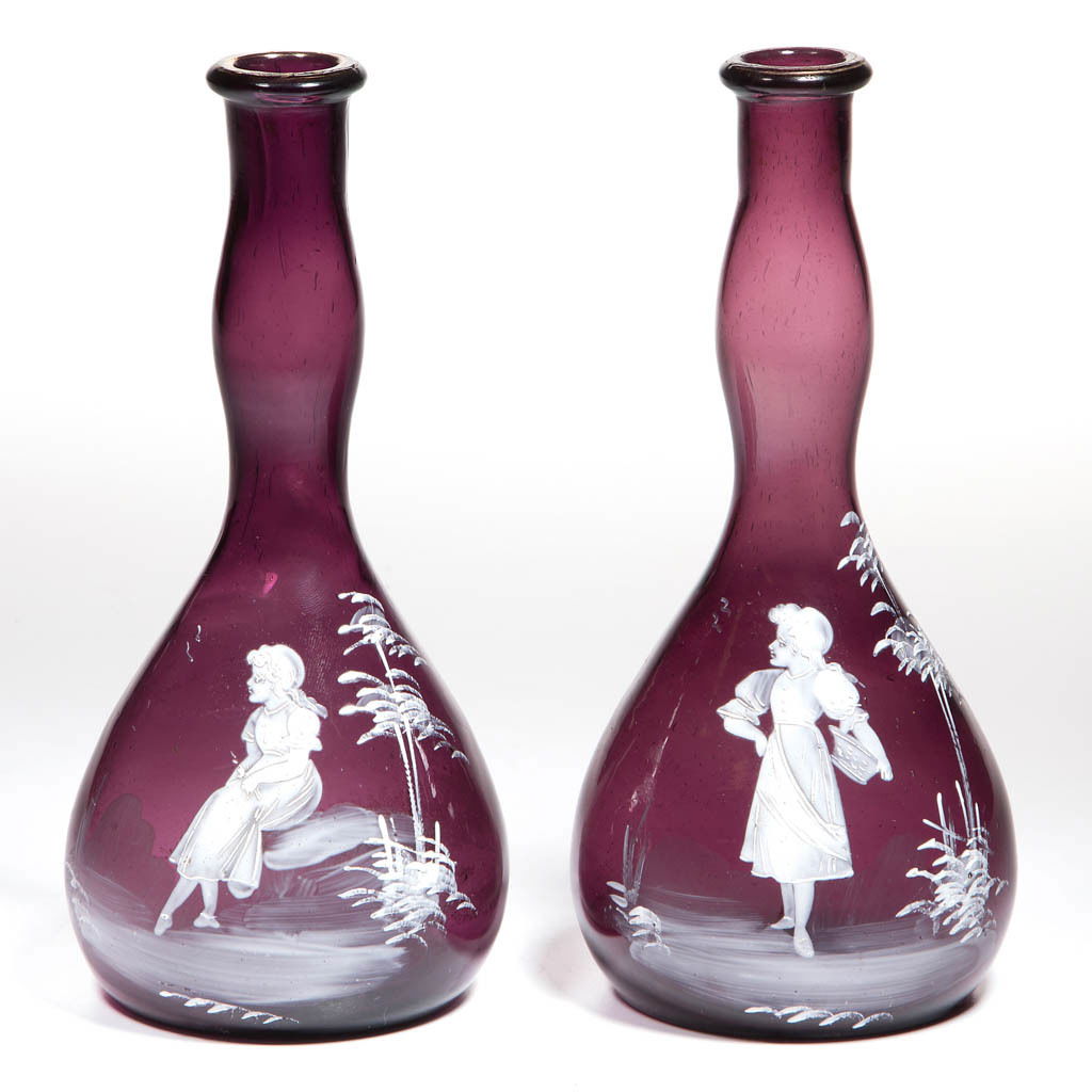 MARY GREGORY (SO-CALLED) BITTERS / BARBER'S BOTTLES,: MARY GREGORY (SO-CALLED) BITTERS / BARBER'S BOTTLES, LOT OF TWO, amethyst with white-enamel decoration, each club form, comprising a girl holding a basket and a girl sitting in on a stone, each with k