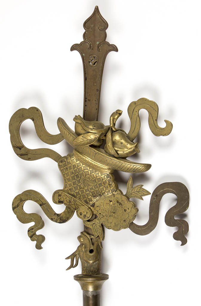 CHINESE CEREMONIAL BRASS SPEAR: CHINESE CEREMONIAL BRASS SPEAR, the spearhead in the form of a bowl or censer with fruit, issuing from the mouth of a dragon-head collar, with smoke or ribbon attachments to the sides, and spear-blade