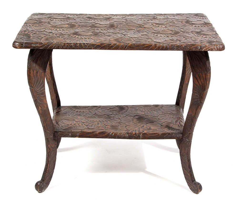 ARTS AND CRAFTS CARVED HARDWOOD SIDE TABLE: ARTS AND CRAFTS CARVED HARDWOOD SIDE TABLE, two-tier, modified cabriole legs and exuberant floral carving throughout, iron brackets attached to underside of lower shelf. Retains an old surface with wa