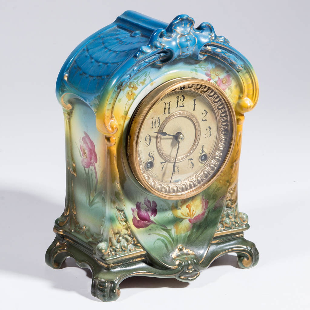 GERMAN ROYAL BONN CERAMIC MANTLE CLOCK: GERMAN ROYAL BONN CERAMIC MANTLE CLOCK, molded with raised feet and cartouche at top and bottom, polychrome glazes with printed floral designs and gilding. Impressed and marked in red "La Cruz" and "R