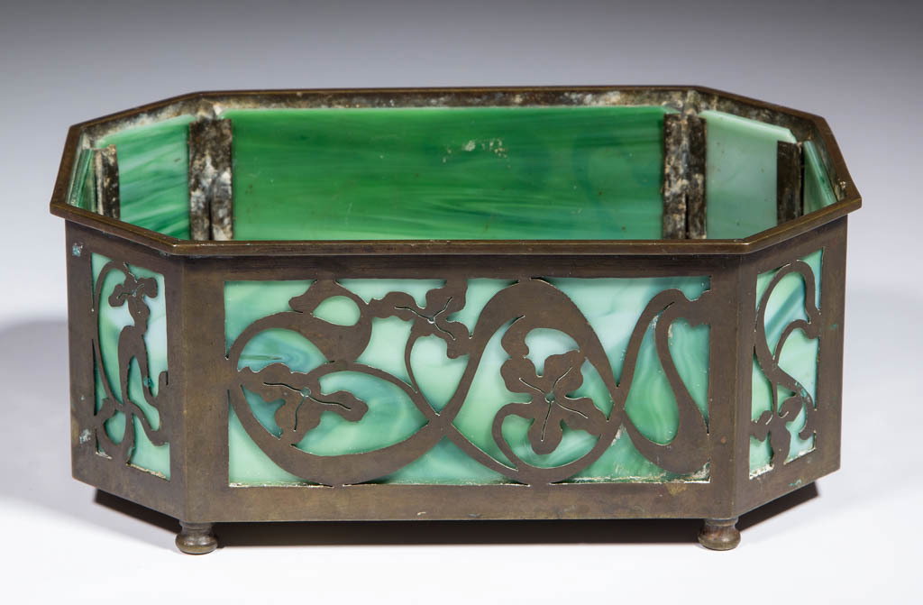 BRASS AND SLAG GLASS FERNER: BRASS AND SLAG GLASS FERNER, green and opal glass, octagonal with a patinated brass frame with a floral motif, spurious Tiffany Studios signature. Maker unverified. 20th century. 3 1/4" H, 5 3/8" x 8"