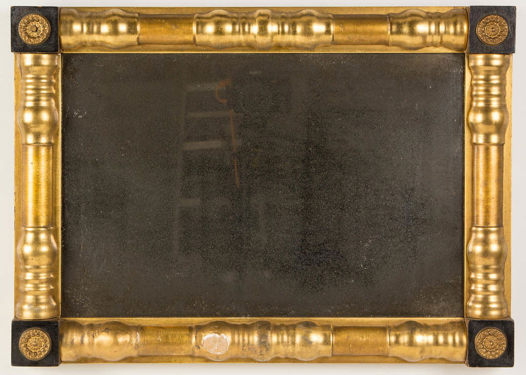 AMERICAN CLASSICAL WALL MIRROR: AMERICAN CLASSICAL WALL MIRROR, split-baluster form having ebonized corner blocks fitted with applied stamped-brass rosettes, pine and poplar secondary woods. Retains likely original gilt surface. Cir