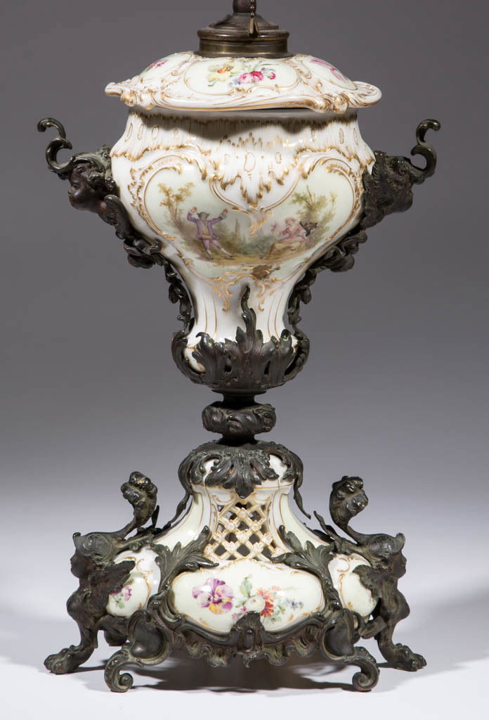 GERMAN KPM MOUNTED PORCELAIN LAMP: GERMAN KPM MOUNTED PORCELAIN LAMP, molded ceramic porcelain components with polychrome and gilt floral decoration and male and female figures, bolted onto metal ormolu base and stand having cherubs an