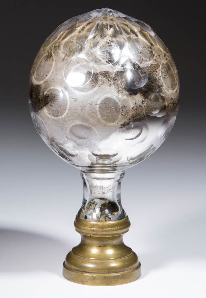 CUT OVERLAY PUNTY FINIAL: CUT OVERLAY PUNTY FINIAL, colorless with a silvered interior, globular form with five rows of punties and star-cut top, applied peg plastered into a brass mount with lower threaded receiver. Probably 