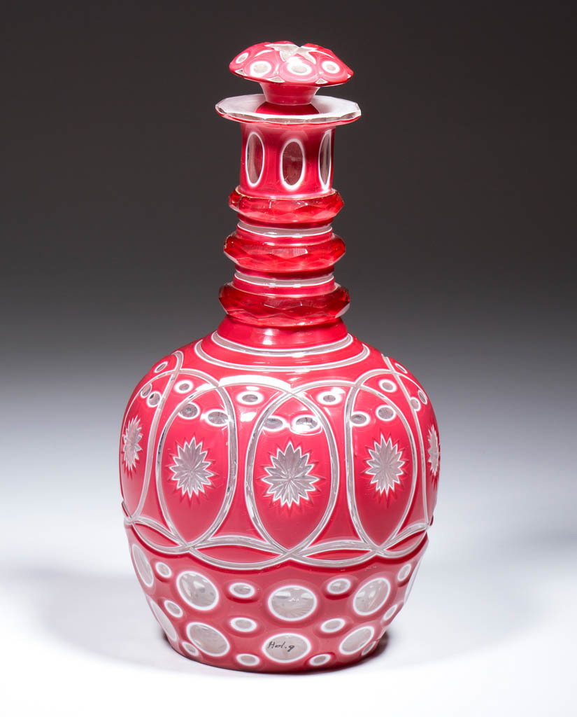 CUT DOUBLE OVERLAY DECANTER: CUT DOUBLE OVERLAY DECANTER, rose to opaque white to colorless, comprising a complex design consisting of oval and star cuts within a band of interlocking rings, on a foundation of alternating oval an