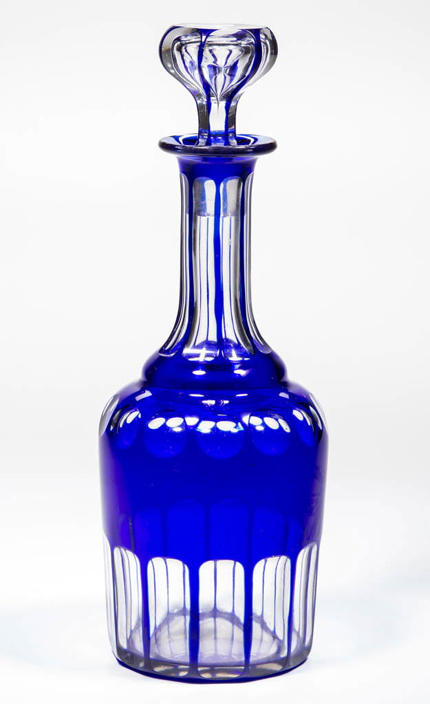 CUT OVERLAY PUNTY AND PANEL QUART DECANTER: CUT OVERLAY PUNTY AND PANEL QUART DECANTER, cobalt blue to colorless, shouldered form with panels around base and neck, polished pontil mark, original hollow stopper numbered to match the bottle. Seco