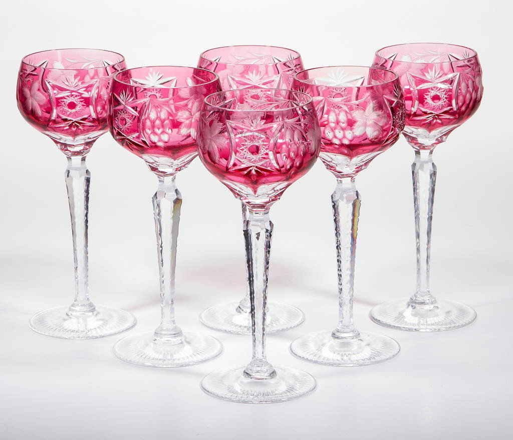 CUT OVERLAY WINE GLASSES, SET OF SIX: CUT OVERLAY WINE GLASSES, SET OF SIX, ruby to colorless lead glass, each with grape and leaf decorations, each having cut-colorless tall stem and foot. 20th century. 8 1/8" H. Undamaged except for one