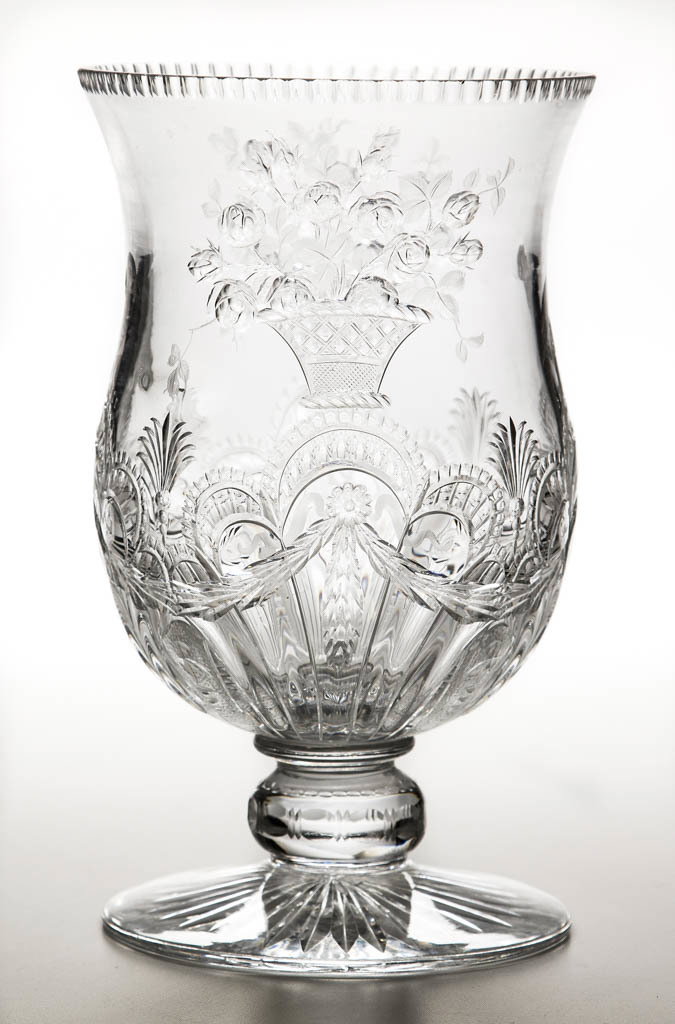 WILLIAM FRITSCHE CUT "ROCK CRYSTAL" VASE: WILLIAM FRITSCHE CUT "ROCK CRYSTAL" VASE, colorless lead glass, large urn from, ornate design featuring baskets with sprawling flowers, perched macaws on two faces over an elaborate design of fans and