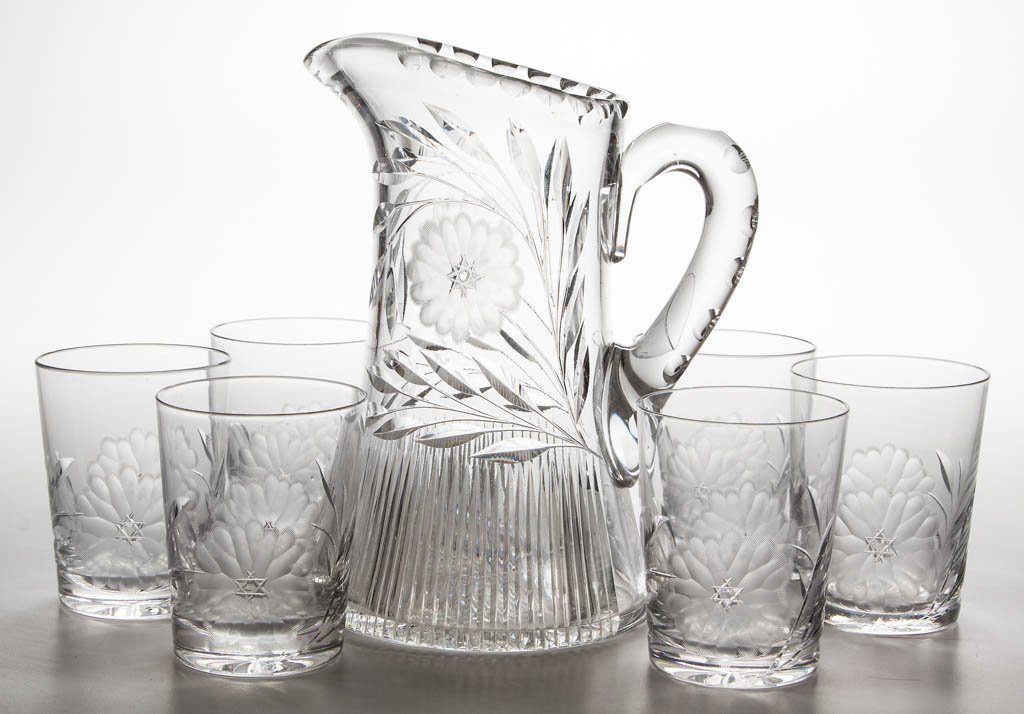 CLARK FLORAL CUT GLASS SEVEN-PIECE WATER SET: CLARK FLORAL CUT GLASS SEVEN-PIECE WATER SET, colorless, comprising a tankard pitcher and six tumblers, pitcher signed under base. First quarter 20th century. 9" and 4" H. Undamaged. Provenance: From 