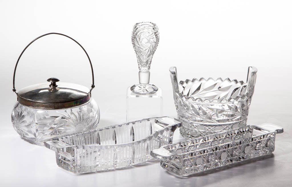 ASSORTED AMERICAN CUT GLASS TABLE ARTICLES, LOT OF FIVE: ASSORTED AMERICAN CUT GLASS TABLE ARTICLES, LOT OF FIVE, colorless, including a floral cut bon-bon with silver-plate mount and cover stamped "0986", and two signed Fry tab-handle dishes, one very fain