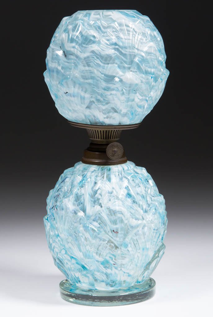 OVERLAPPING SHELLS / PETALS SPATTER GLASS MINIATURE: OVERLAPPING SHELLS / PETALS SPATTER GLASS MINIATURE LAMP, colorless with blue and opal spatter, elongated egg-form font with colorless applied circular plain foot, matching patterned ball-form shade, 
