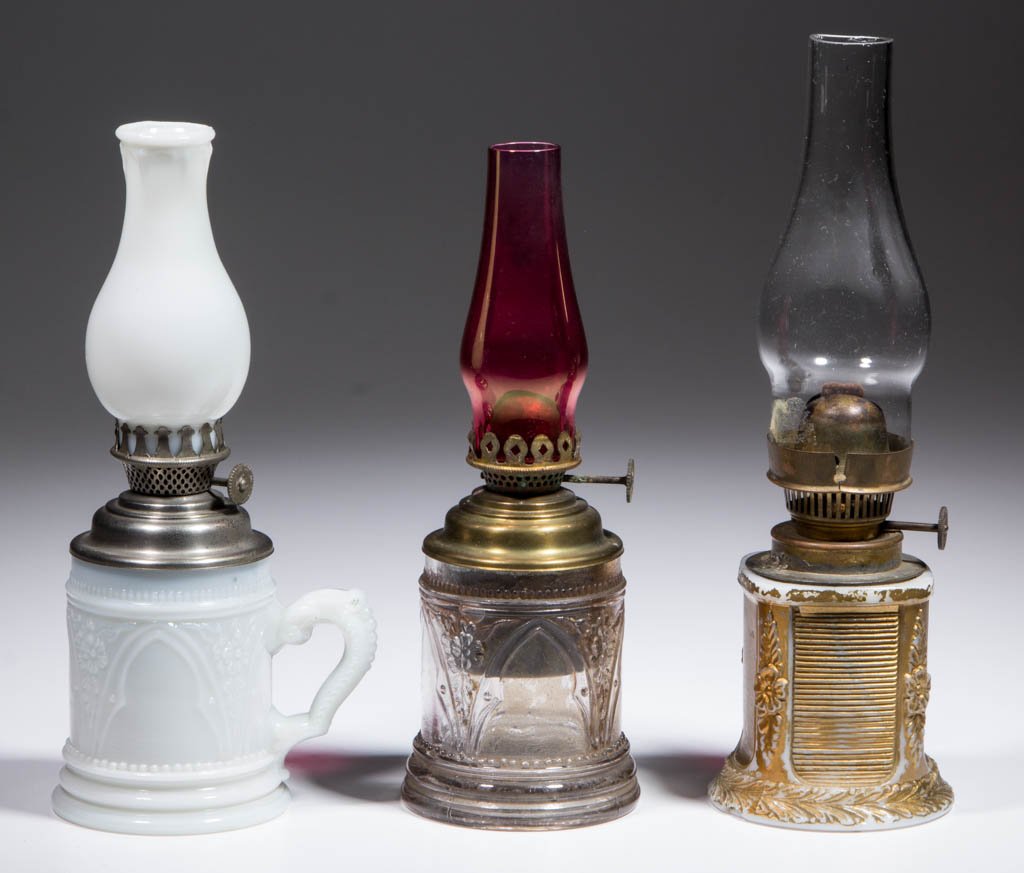 ASSORTED PATTERN MINIATURE LAMPS, LOT OF THREE: ASSORTED PATTERN MINIATURE LAMPS, LOT OF THREE, comprising an opaque white finger and a colorless Gothic Arch/Smith I, fig. 163 and 164 examples; and an opaque white with gold enamel wreath embossed e