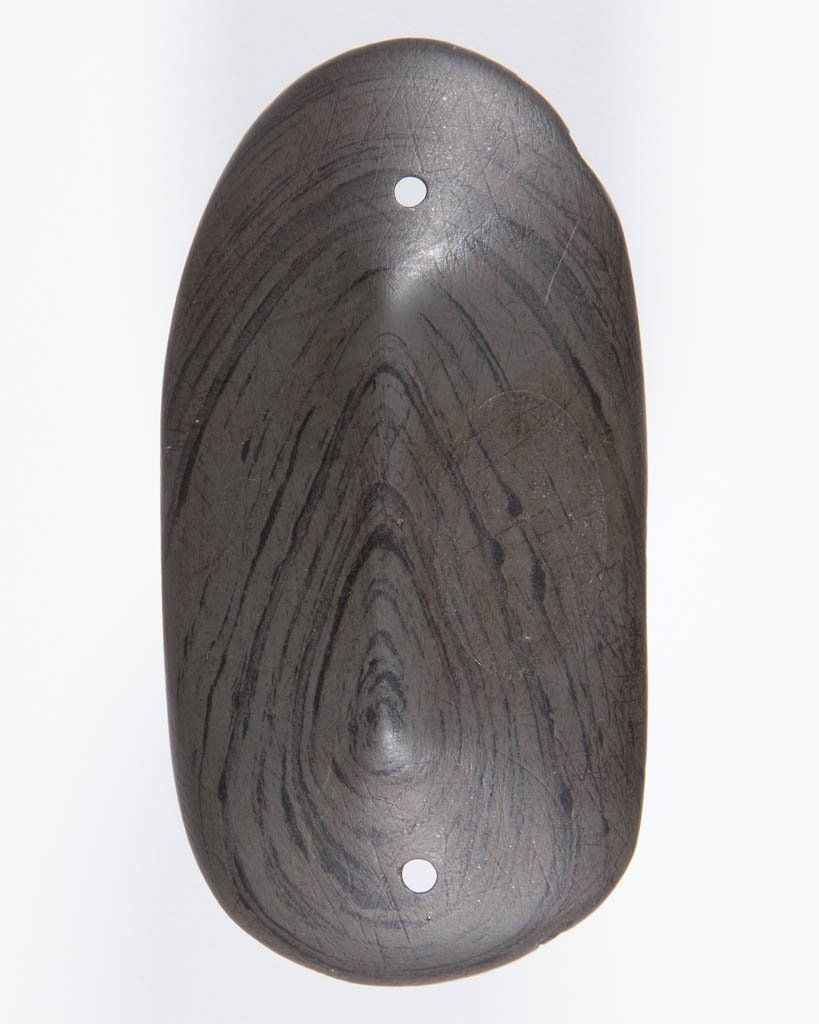 NATIVE AMERICAN BANDED SLATE GORGET: NATIVE AMERICAN BANDED SLATE GORGET, keeled or peaked form, rounded ends, parallel sides, and flat back, with hole to either end. Collection information to back "GUSLER COLL. / OHIO". Adena culture. M