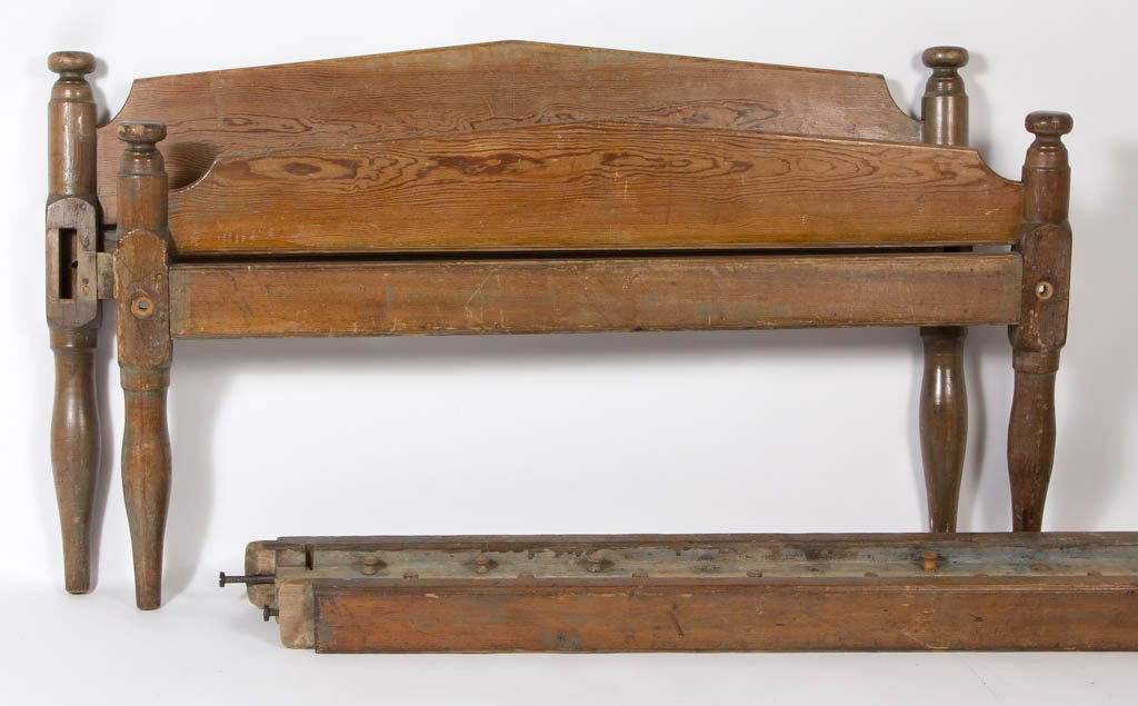 AMERICAN COUNTRY PINE AND POPLAR ROPE BED: AMERICAN COUNTRY PINE AND POPLAR ROPE BED, peaked headboard and footboard, turned posts with mushroom finials, and remnants of early green-painted surface. First half 19th century. 29 1/4" HOA, 74" L,