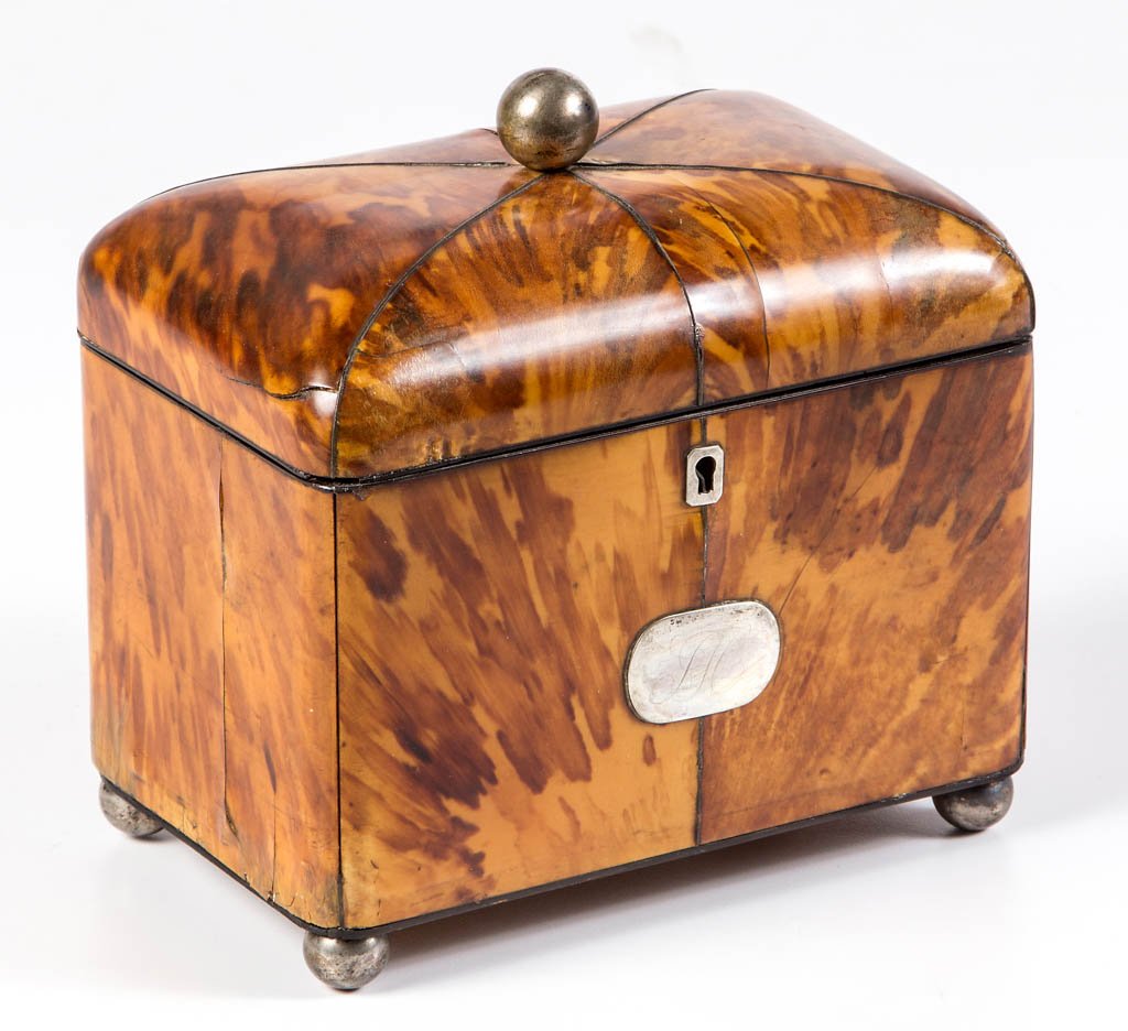 GEORGE IV TORTOISE SHELL TEA CADDY: GEORGE IV TORTOISE SHELL TEA CADDY, the hinged lid concealing a divided interior with original covers, Sheffield plated-silver lid finial, escutcheon, monogrammed name plate, and ball-form feet. Retai
