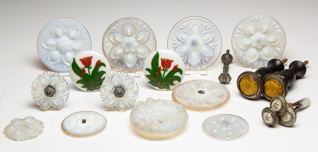 ASSORTED GLASS CURTAIN PINS / TIE BACKS, LOT OF 18: ASSORTED GLASS CURTAIN PINS / TIE BACKS, LOT OF 18, including 11 pressed fiery opalescent examples, six complete with shank. Boston & Sandwich Glass Co. and others. 1840-1890. 1 1/8" to 3 1/2" D faces