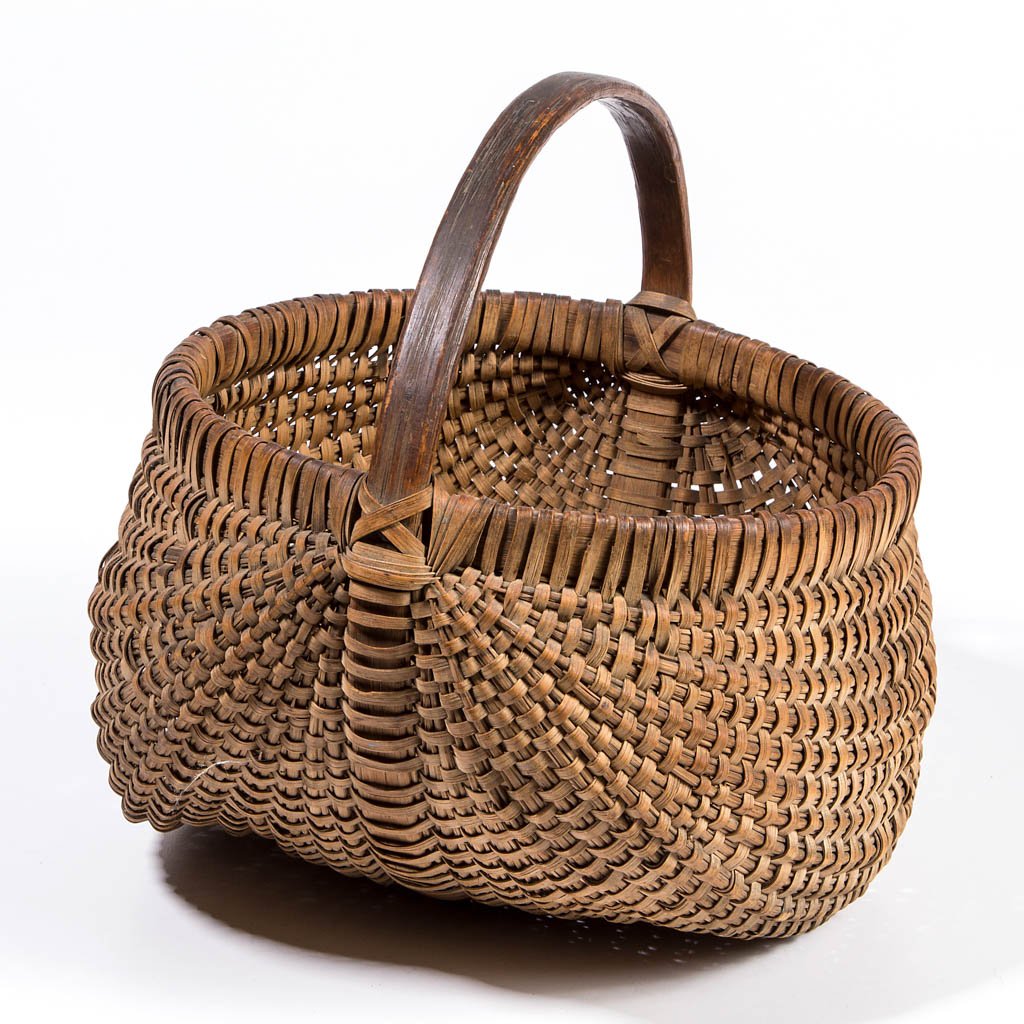 APPALACHIAN RIB-TYPE WOVEN-SPLINT BASKET: APPALACHIAN RIB-TYPE WOVEN-SPLINT BASKET, white oak, kidney form having unusual bundled converging ribs, arched handle with wrapped attachment, wrapped rim. Retains likely original dry natural surface