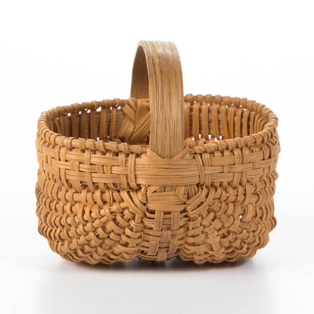 APPALACHIAN RIB-TYPE WOVEN-SPLINT MINIATURE BASKET: APPALACHIAN RIB-TYPE WOVEN-SPLINT MINIATURE BASKET, white oak, finely woven oblong kidney-form with woven-over rim, arched handle, and simple X-shape handle supports. Original dry natural surface. Mid